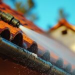 A powerful pressure washer in action, cleaning a dirty roof surface, demonstrating the efficiency of modern roof maintenance